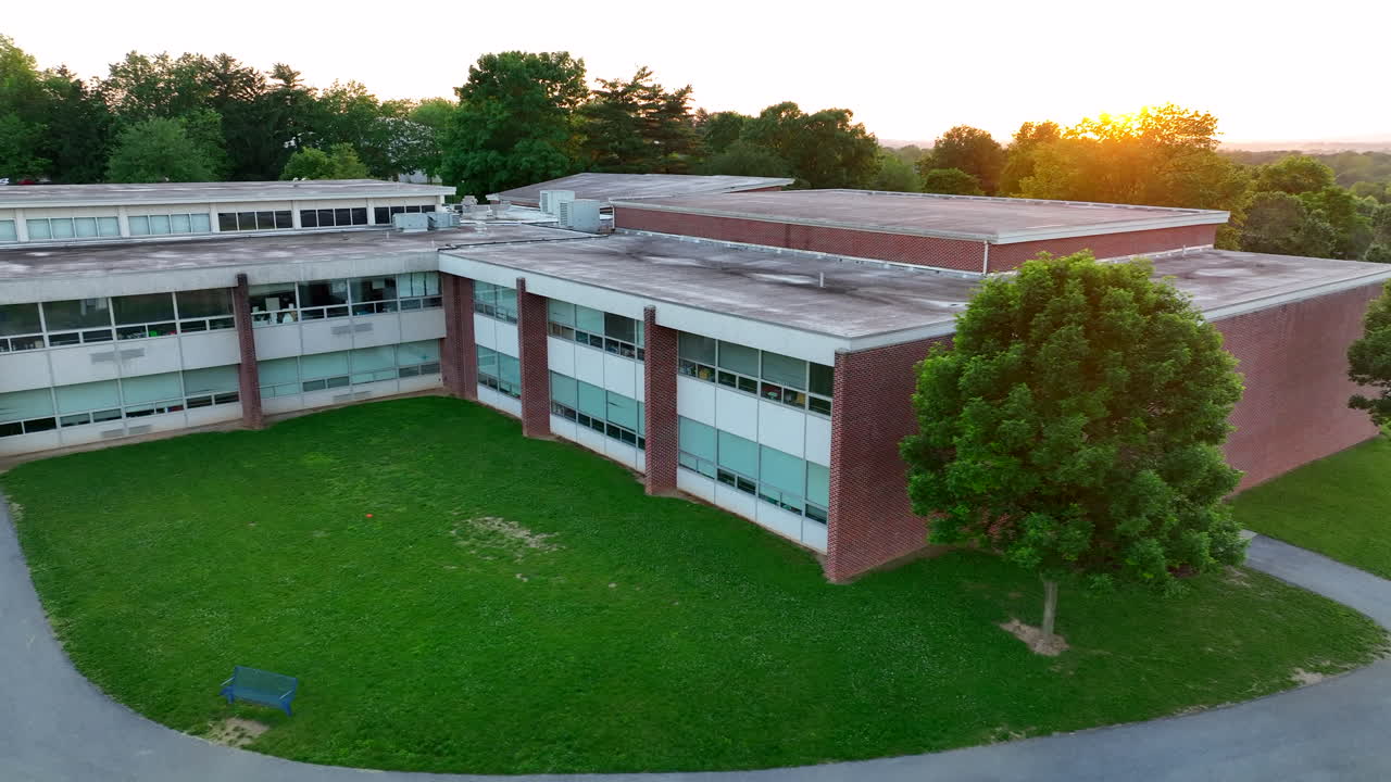Aerial view of sunset over American elementary school. Old elementary school during spring