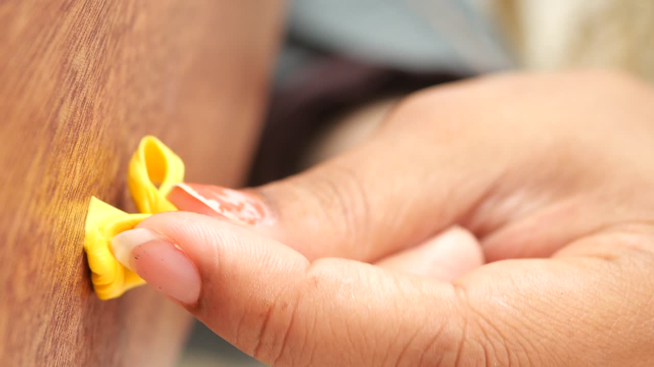 Person Pulling on Yellow Gum