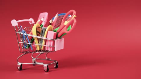 acercamiento del carrito de compras con artículos escolares con espacio de copia en fondo rojo