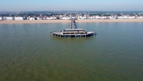 deal pier with beach and town in background