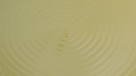 Concentric-circles-forming-in-a-yellow-liquid