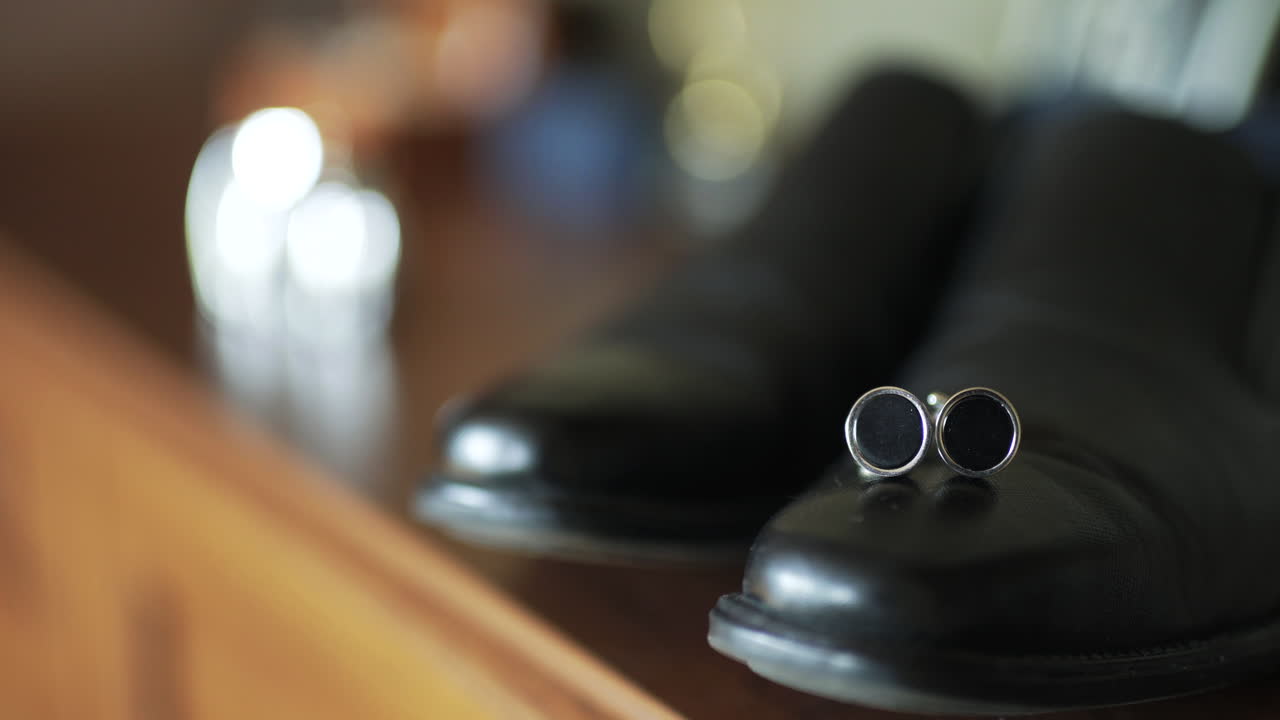 Elegant Cufflinks Placed on Polished Black Dress Shoes