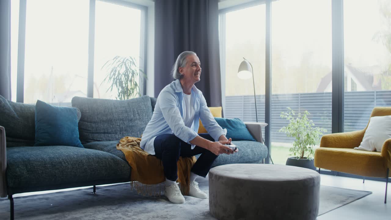 Man playing video games on couch