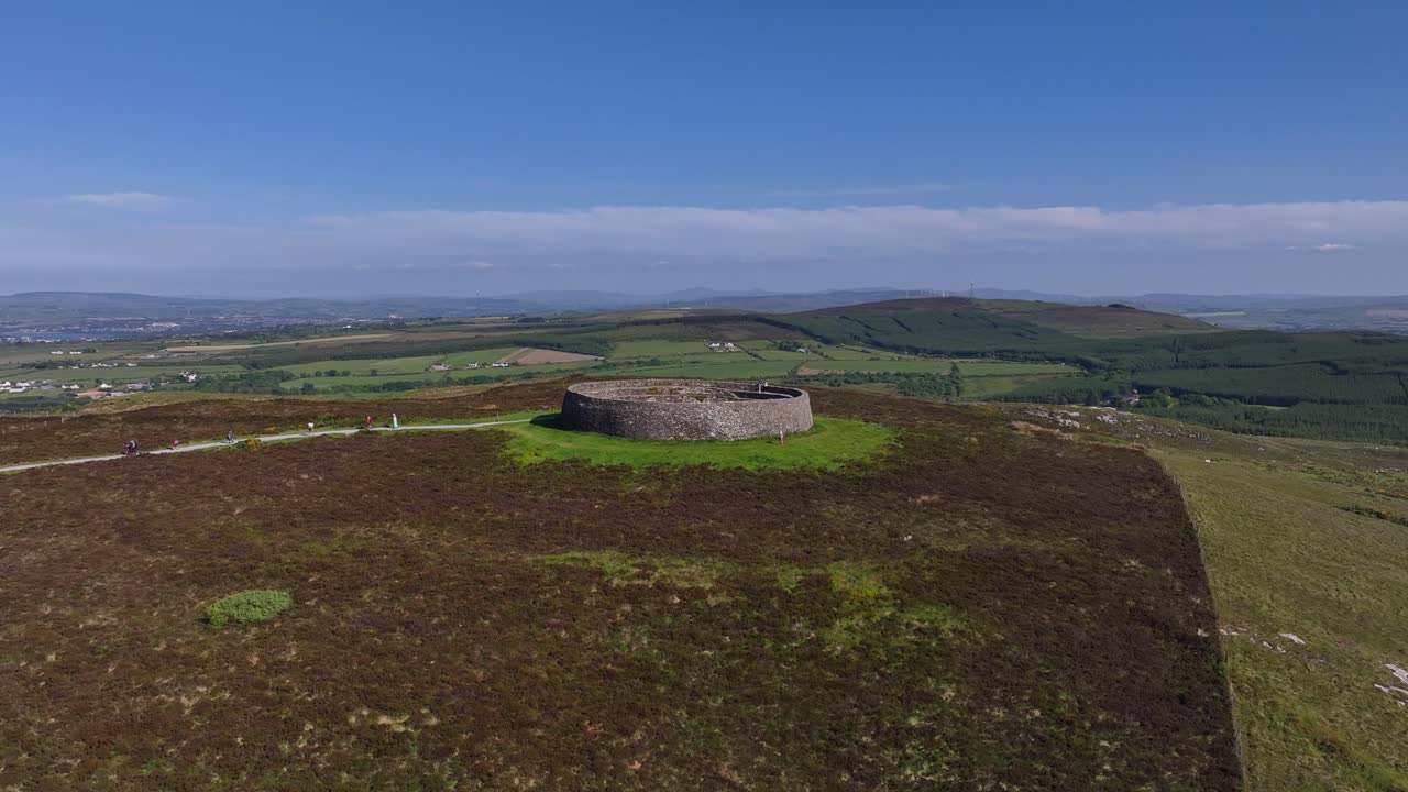 Grianan of Aileach, County Donegal, Ireland, June 2023. Drone gradual aerial ascent above the spectacular Gaelic Ringfort, revealing the scenic countryside and rolling hills surrounding historic site.