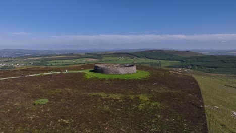 grianan of aileach, county donegal, ireland, june 2023. drone gradual aerial ascent above the spectacular gaelic ringfort, revealing the scenic countryside and rolling hills surrounding historic site.