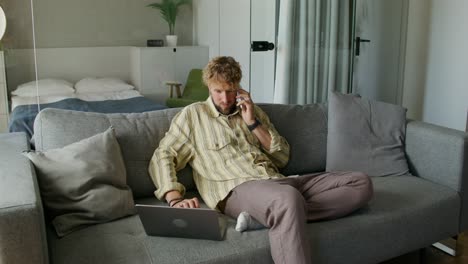 man working from home on couch