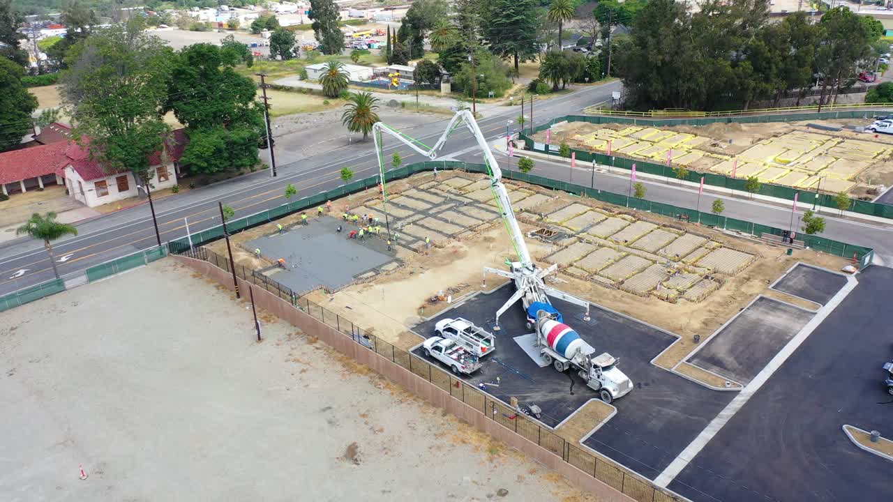 Remarkable Aerial Over Construction Site With Giant Crane And Workers Pouring Concrete Foundation In Ventura California 2