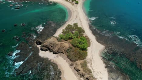 Drone-tilt-down-view-of-Tropical-San-Juanillo-Beach-Shore-With-Rocky-Coast-And-Blue-Ocean-Waves,-Costa-Rica