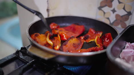 red bell peppers cooked in pan add sweetness and depth to classic bagna cauda.