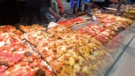 variety of pizzas and italian foods displayed