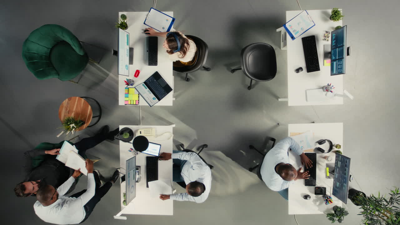 Top down view of business colleagues reviewing data and proposals