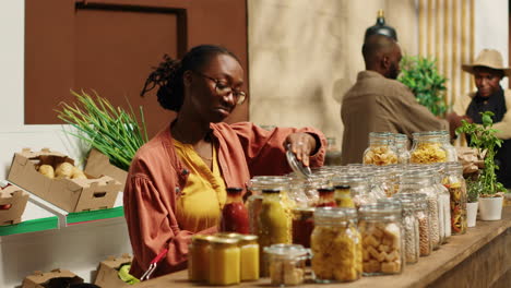 Vegan-client-examining-types-of-pasta-on-sale-at-zero-waste-store