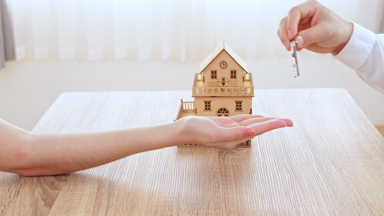 Agent Giving Keys Of New House With Customer