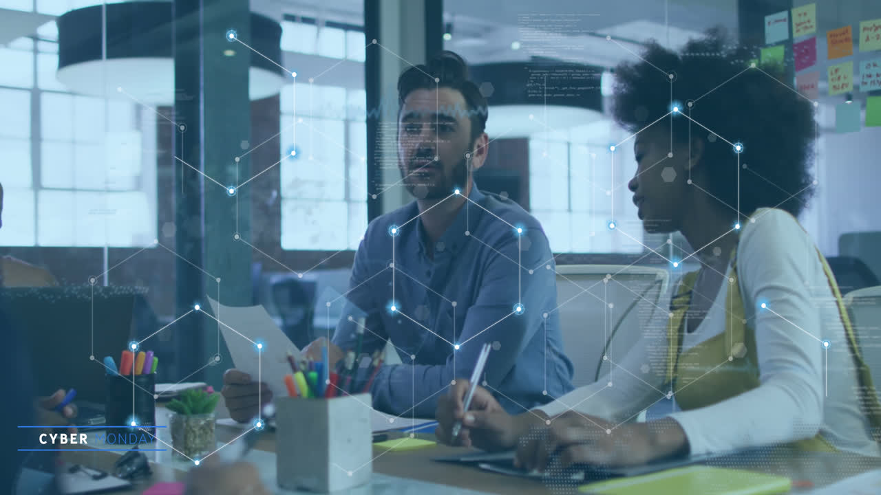 Animation of connected dots forming hexagons over diverse man discussing with colleagues in meeting