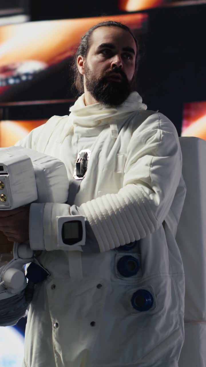 Vertical Video Curious astronaut standing on a distant planet in space suit and helmet