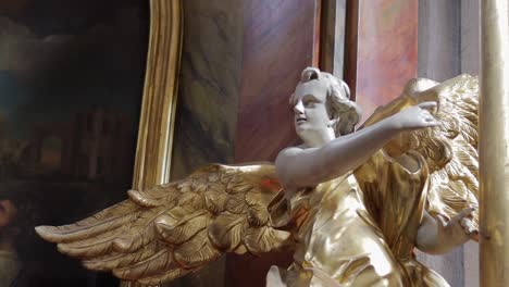 statue of an angel with wings in a gilded robe