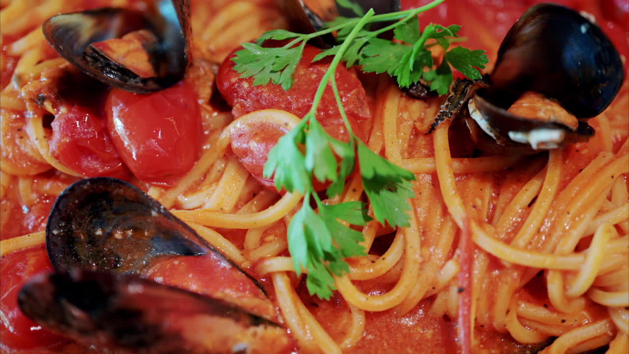 Close up of pasta with tomato sauce and mussels