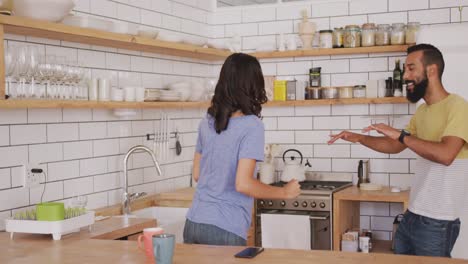 happy couple dancing together in the kitchen