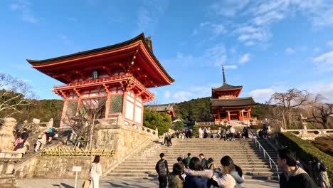 tourists ascending steps to a traditional gate