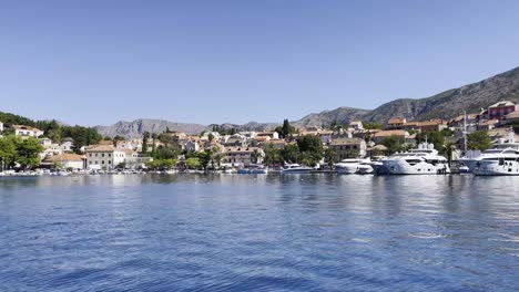 sunny cavtat marina with town panorama from the adriatic, croatia