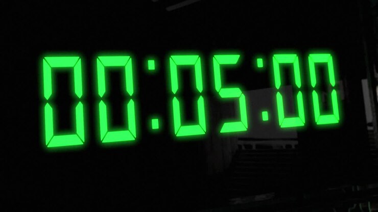 High quality CGI render of a digital countdown timer on a wall-mounted screen, with glowing green numbers, counting down from 10 to zero, with dramatic left to right camera move