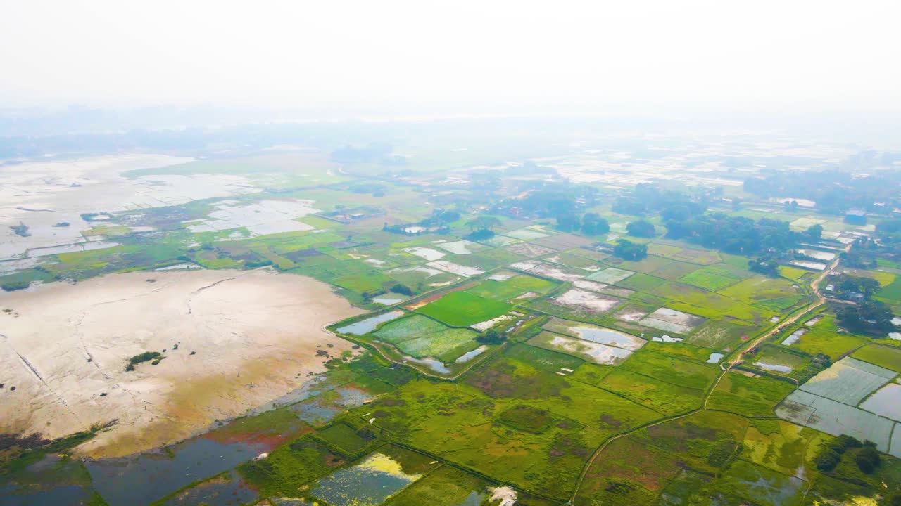 Birds eye view over vast cultivated and irrigated green fields during summer season. Aerial