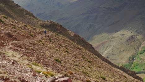 Tourist-in-the-distance-walking-towards-the-camera-in-High-Atlas,-Morocco