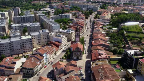 Aerial-view-of-Igreja-de-São-Vicente-amidst-the-urban-streets-and-buildings-of-Braga,-Portugal