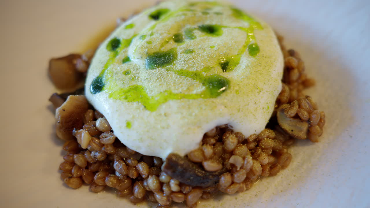 Sardinian Fregula with sauce dish on a white plate