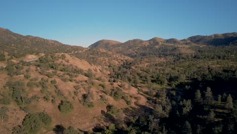 Sierra-Nevada-mountains-and-highway-in-California,-golden-hour,-Aerial-Parallax