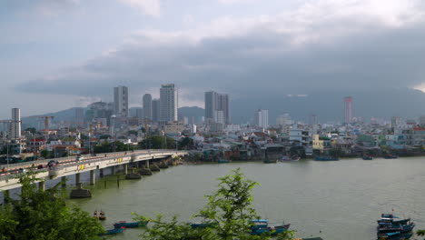 view of traffic on xom bong bridge over cai river and nha trang city skyline, khanh hoa province, central vietnam