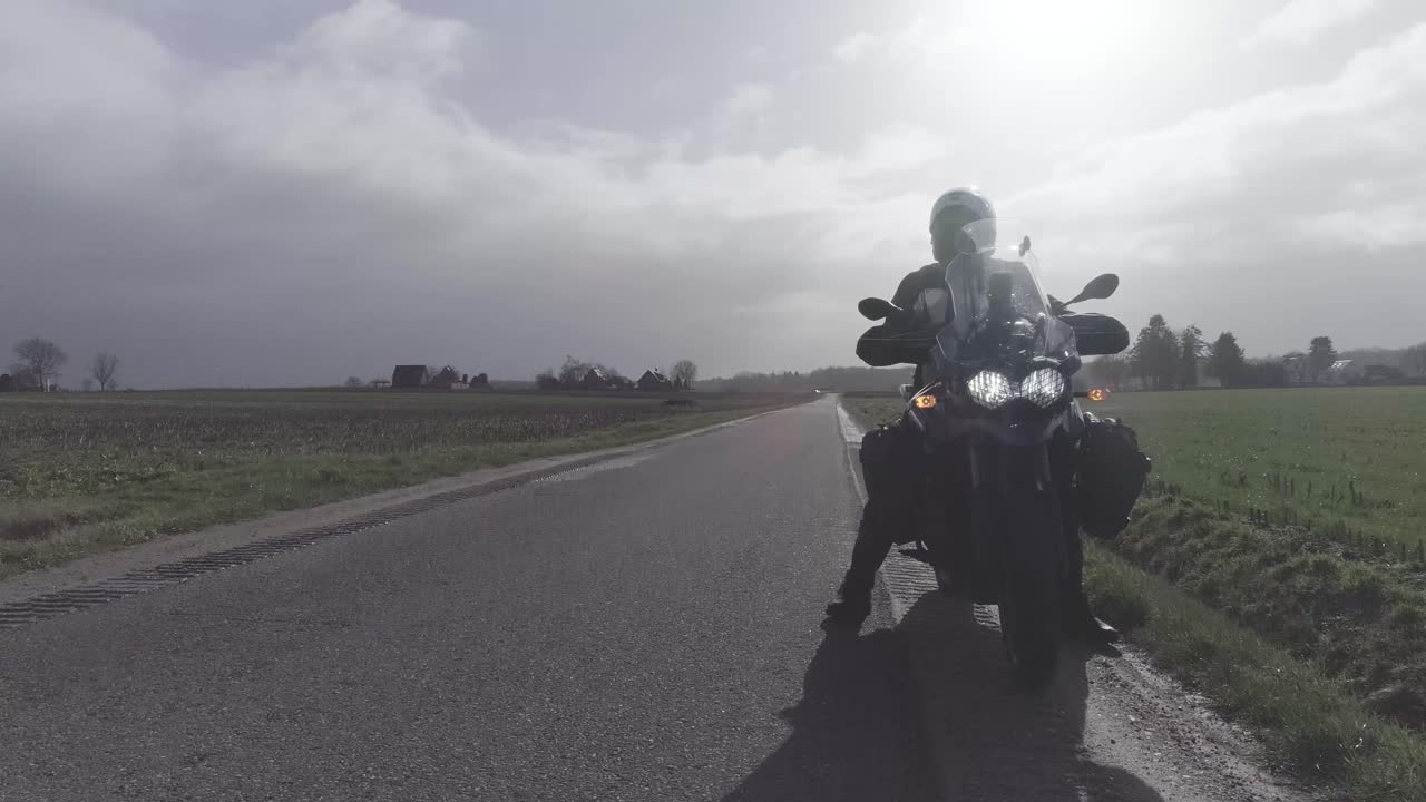 Drone shot from the ground up of motorcyclist