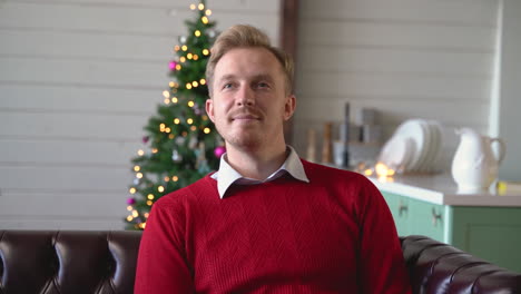 Blond-Man-Sitting-On-The-Sofa-Changing-The-Tv-Channel