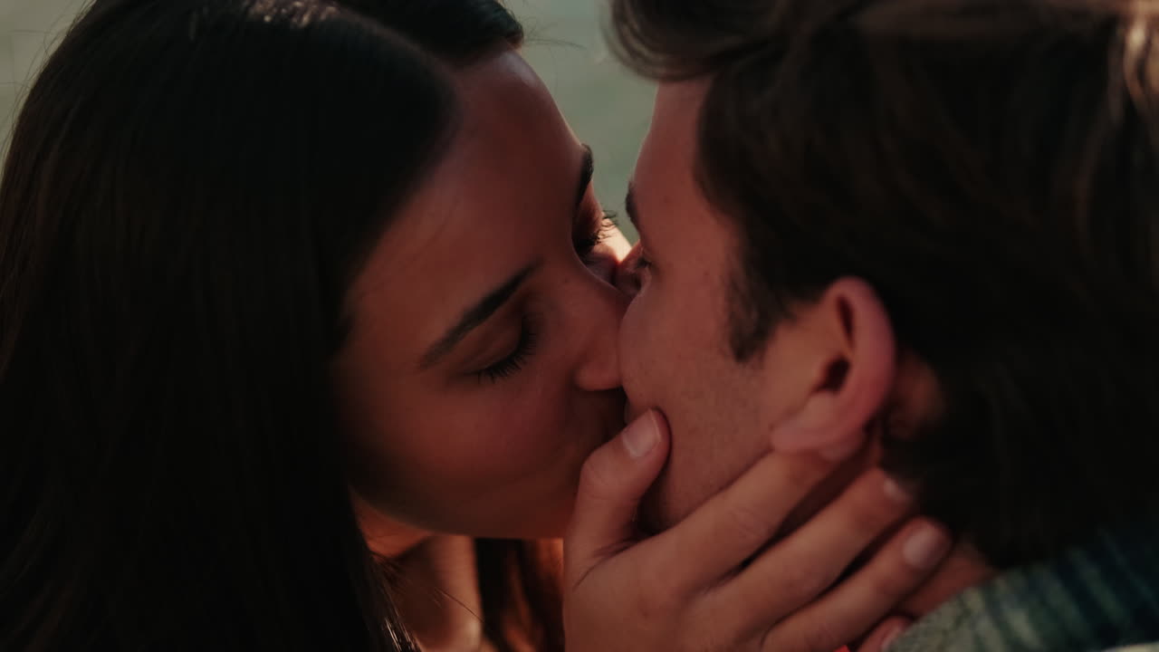 Young Couple's Tender Kiss by the Water