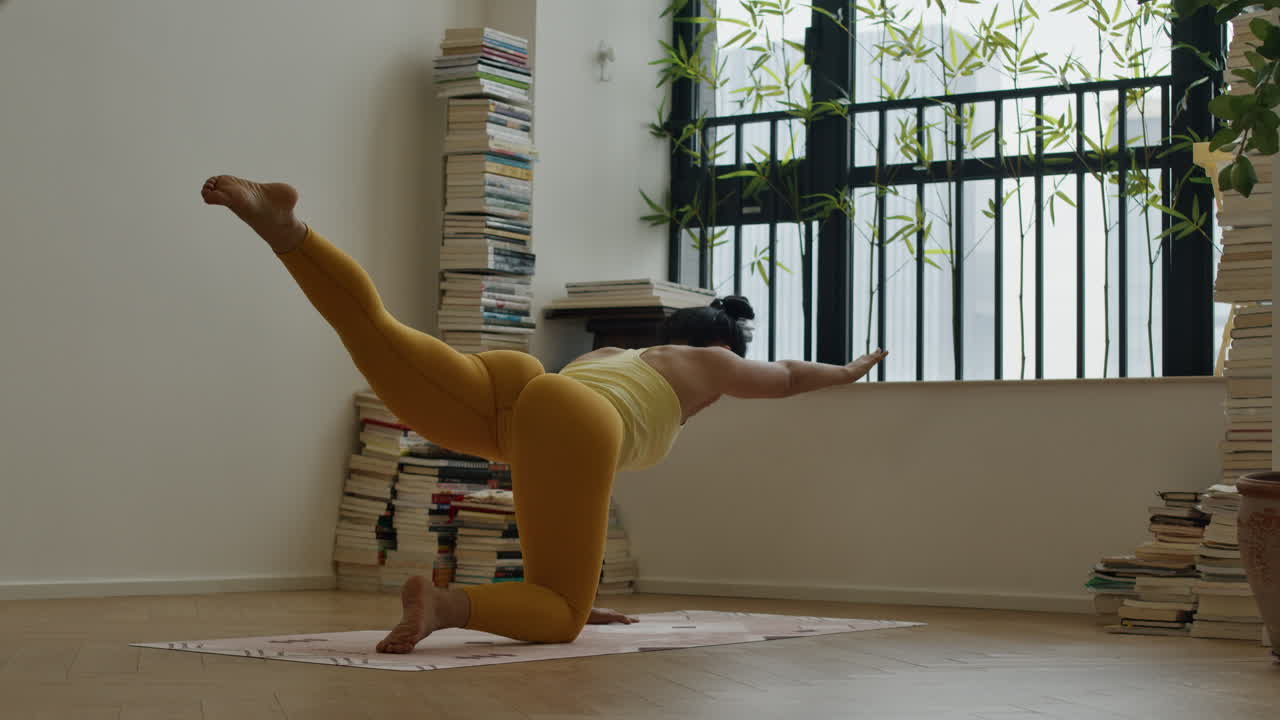 Fit athletic asiatic woman practicing yoga workout routine in modern house apartment