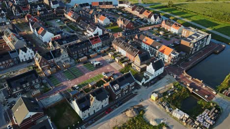 Aerial-overview-of-a-modern-suburban-neighborhood-with-photovoltaic-solar-panels-on-rooftop-at-golden-hour