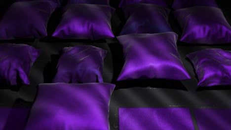 purple satin pillows on dark background