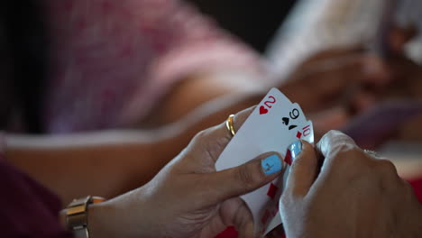 one woman holding 3 cards for playing in cruise singapore poker