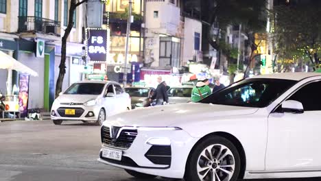 motorbikes and cars navigating a bustling intersection