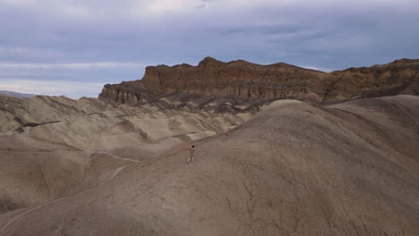 people hiking through unique desert formations