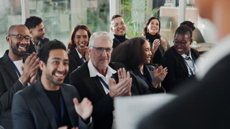 audience applauding a speaker at a business conference