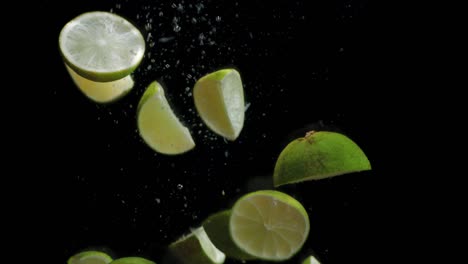 pieces of ripe lime falling into the water.