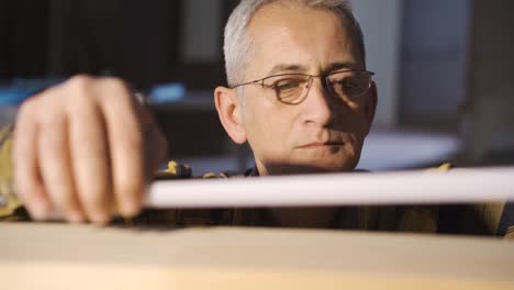 carpenter master measures wood with meters.