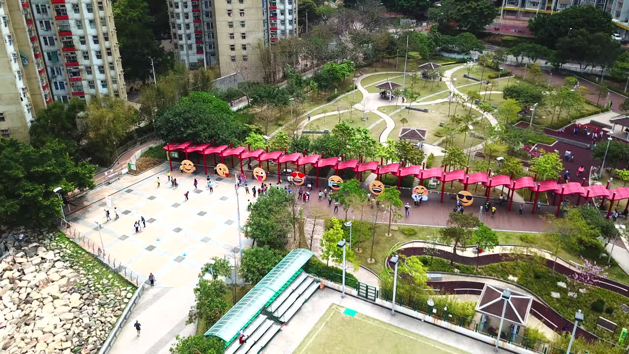 Aerial Footage, People walking in Garden with Emojis on it.
