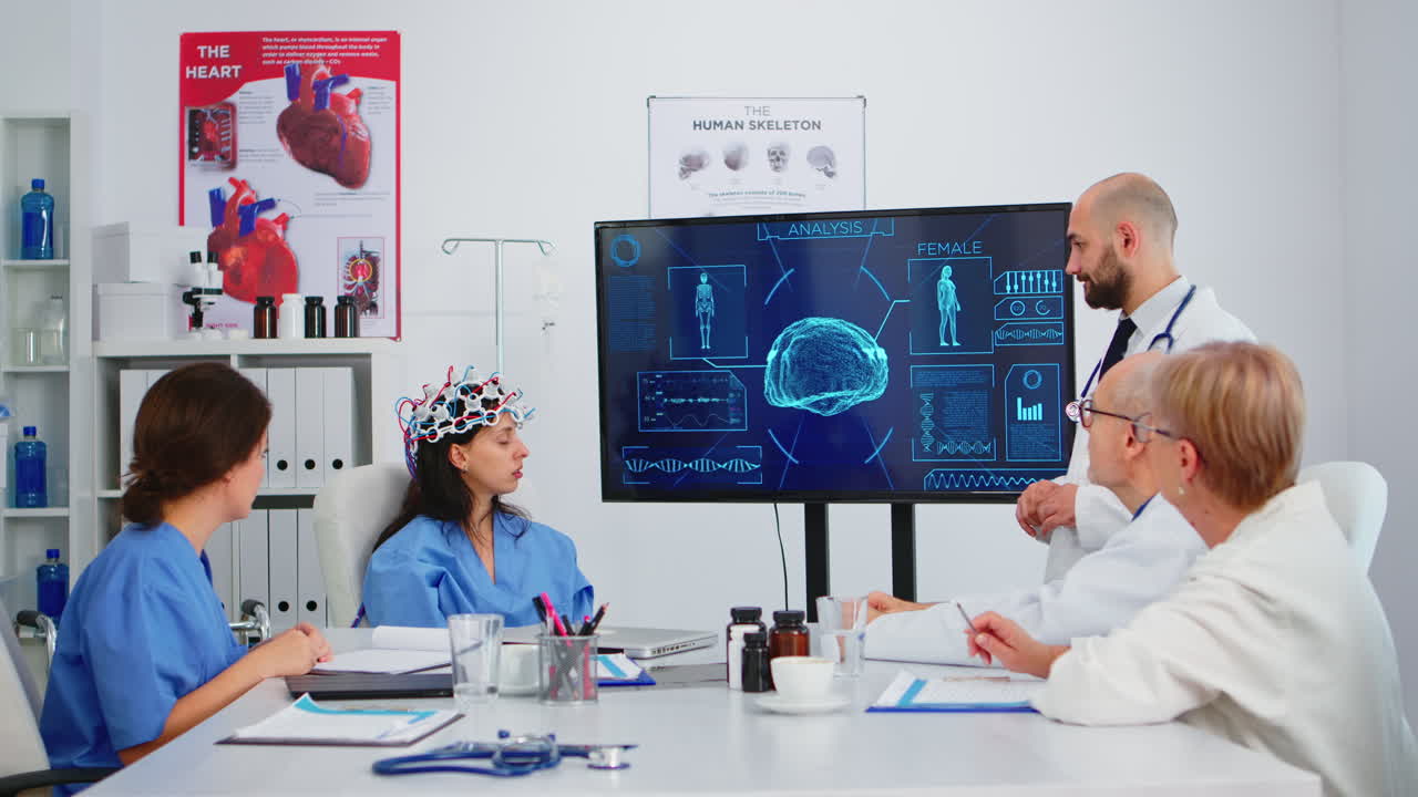 Neurologist showing new inovation for brain control to colleagues ...