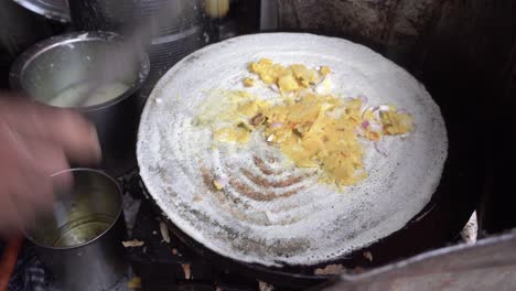 a street food maker prepares the south indian food dhosa