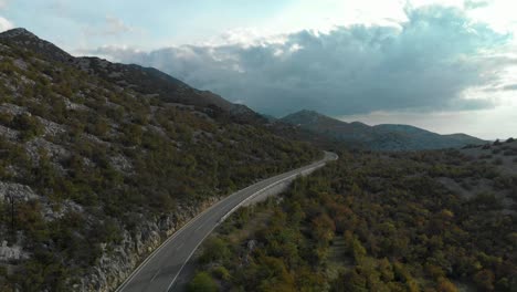 Aerial-drone-shot-over-car-road-located-near-sea-3