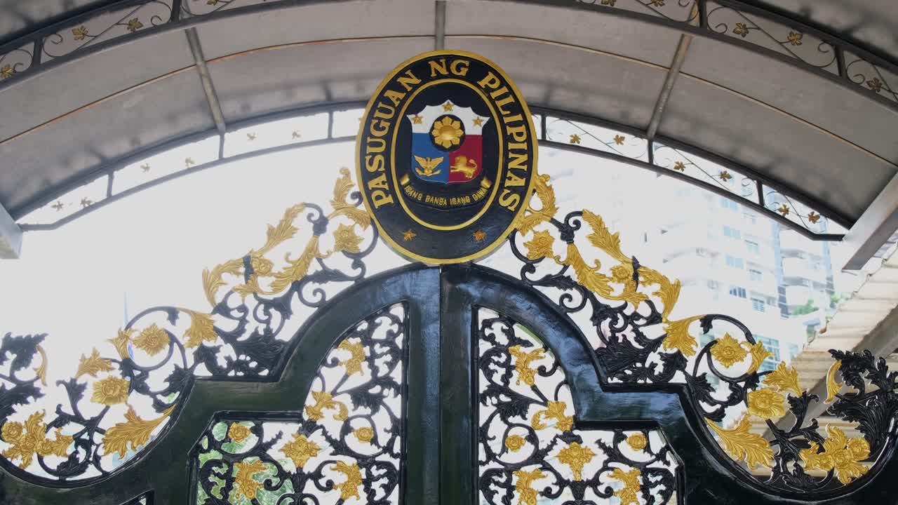 Zooming out of the Philippine Embassy seal on top of the front gate of the consular building, located in Sukhumvit street, Bangkok, Thailand