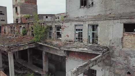 aerial view of abandoned industrial buildings. abandoned factory halls with broken glass on windows.