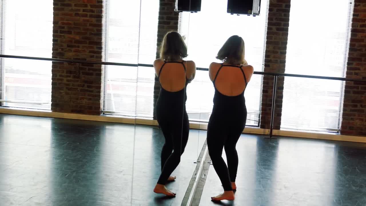 Ballerina practicing in front of mirror